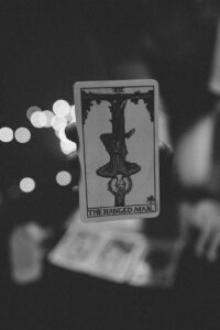 The 78 Cards of the Tarot as Feelings in Love Artistic black and white photo of a tarot card with bokeh lights, perfect for mystical themes.